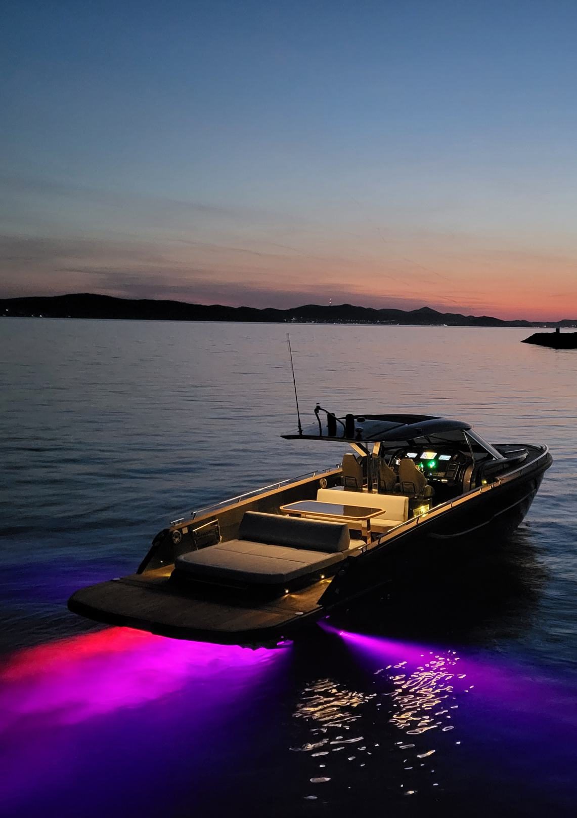Forza 37 at anchor at dusk with underwater lighting